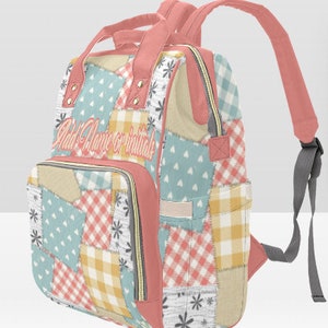 May include: A pink patchwork backpack with a zippered front pocket and adjustable straps. The backpack has a patchwork design with various colors and patterns, including blue, yellow, and pink. The text "Add Name or Initials" is printed on the front of the backpack.