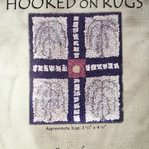 May include: Punchneedle embroidery pattern for a rug with a geometric design featuring four squares with a central square in a different color. The pattern is titled "Hooked on Rugs" and is designed by M Wylie. The rug is approximately 3 3/4 inches by 4 1/4 inches.