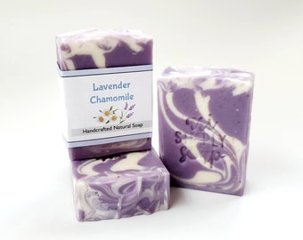 May include: Three bars of handmade lavender chamomile soap. The soap is a swirl of purple and white. The top bar has a label that reads "Lavender Chamomile Handcrafted Natural Soap".