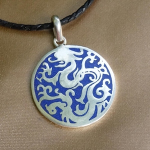 Beautiful amulet handmade in Nepal with Tibetan dragons, lapis lazuli