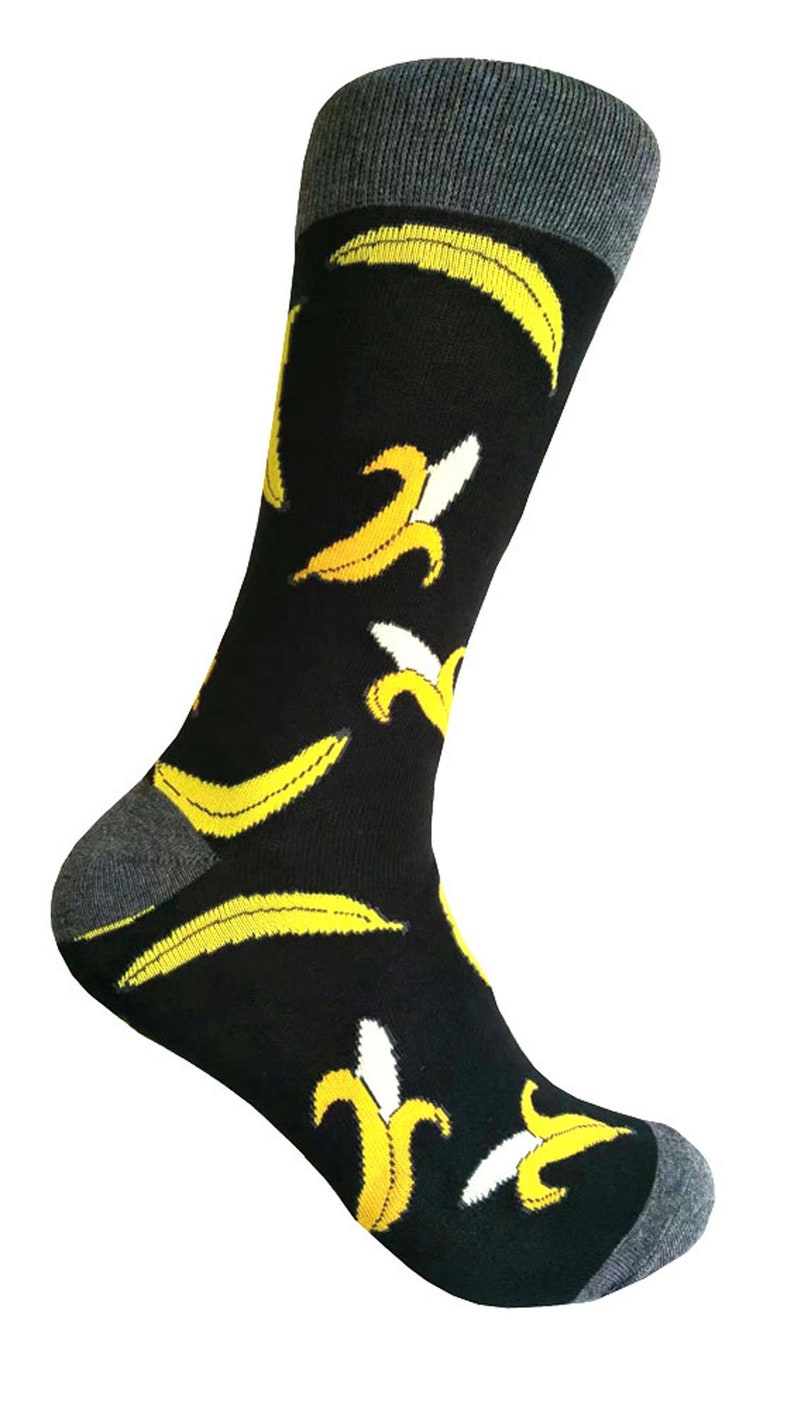 May include: Black socks with a yellow banana pattern. The socks have a grey cuff.