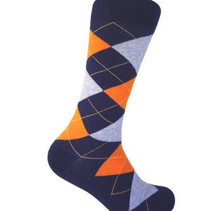 May include: A pair of blue socks with a diamond pattern in orange and gray.