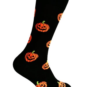 May include: Black socks with a pattern of orange jack-o'-lantern faces.