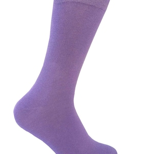 May include: A pair of purple socks. The socks are made of a soft, comfortable material and have a classic crew length.