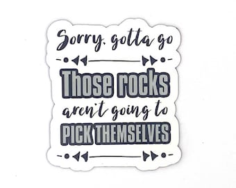 May include: White sticker with black text that reads "Sorry, gotta go. Those rocks aren't going to pick themselves."  The text is surrounded by black arrows.