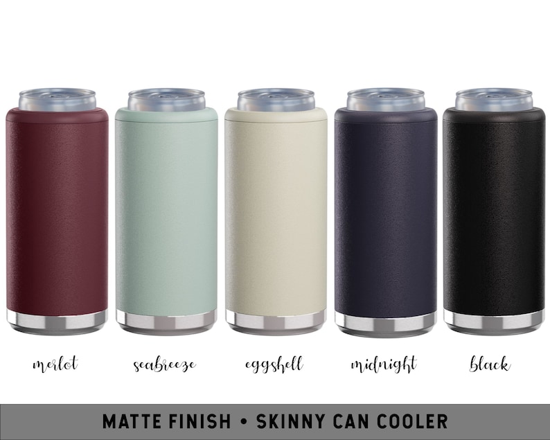 May include: A collection of five matte finish skinny can coolers in various colors: merlot, seabreeze, eggshell, midnight, and black. Each cooler has a silver rim at the top and bottom. The text at the bottom reads "MATTE FINISH &bull; SKINNY CAN COOLER".