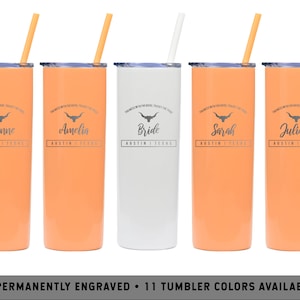May include: Five stainless steel tumblers with orange and white finishes. Each tumbler has a straw and features a black and white graphic of a longhorn steer with the text "You mess with the bride, you mess with the crew" and a personalized name. The names are Leanne, Amelia, Bride, Sarah, and Juliana. The text "Austin, Texas" is also included on each tumbler.