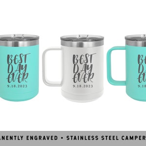 May include: Three stainless steel camper mugs with a handle. The mugs are engraved with the text "Best Day Ever" and the date "9.18.2023". One mug is turquoise, one is white, and one is light blue.