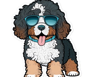 May include: A cartoon illustration of a Bernedoodle dog wearing blue sunglasses and sticking its tongue out. The dog has black, white, and brown fur.