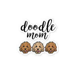 May include: Doodle Mom text with three cartoon doodle dogs. The dogs are brown, cream, and apricot.
