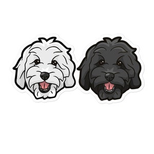 Könnte beinhalten: Zwei Aufkleber mit Cartoon-Hundegesichtern. Einer ist weiß mit schwarzem Umriss, der andere schwarz mit weißem Umriss. Beide haben offene Münder mit rosa Zungen und braunen Augen, ideal zum Dekorieren.