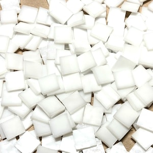 May include: A large pile of small, white, square ceramic tiles.