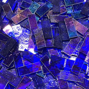 May include: A pile of iridescent blue glass tiles, ideal for crafting and mosaic projects.