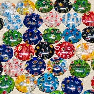 May include: Assortment of colorful glass buttons with various floral patterns. The buttons are round and have a glossy finish.