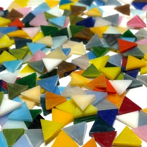 May include: A large assortment of colorful glass triangle mosaic tiles. The tiles are in various shades of blue, green, yellow, red, orange, pink, and white.