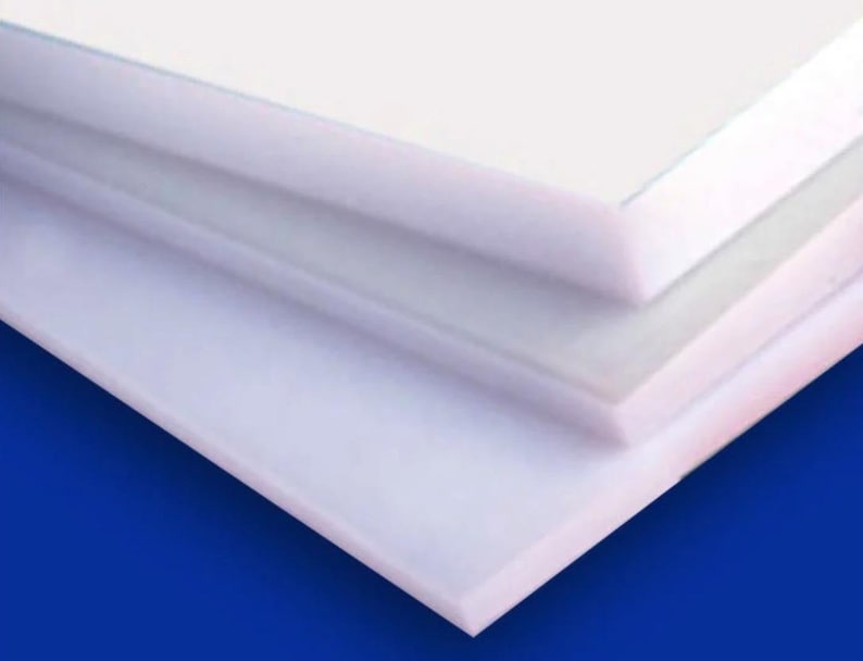 May include: Stack of three white plastic sheets, each with a smooth, glossy surface. The sheets are layered on top of each other, creating a clean and modern look.