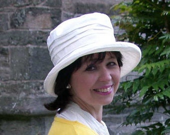 Classic white linen sun hat for ladies with stiffened brim, packs and travels well.