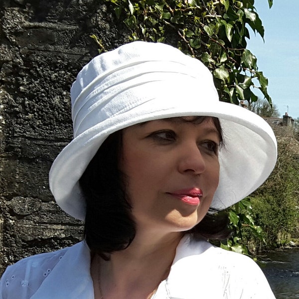 Classic linen sun hat in four colours for women. Stiffened brim, packs and travels well. Denim, white, cream and stone. Two adjustable sizes