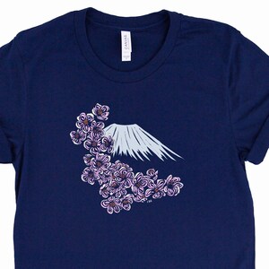 May include: A navy blue t-shirt with a white graphic of Mount Fuji and pink cherry blossoms.