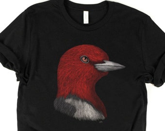 May include: Black t-shirt with a red and gray illustration of a red-headed woodpecker.