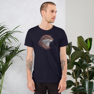 May include: A navy blue t-shirt with a graphic of an otter's head. The otter is brown with a white chest and is looking to the right.