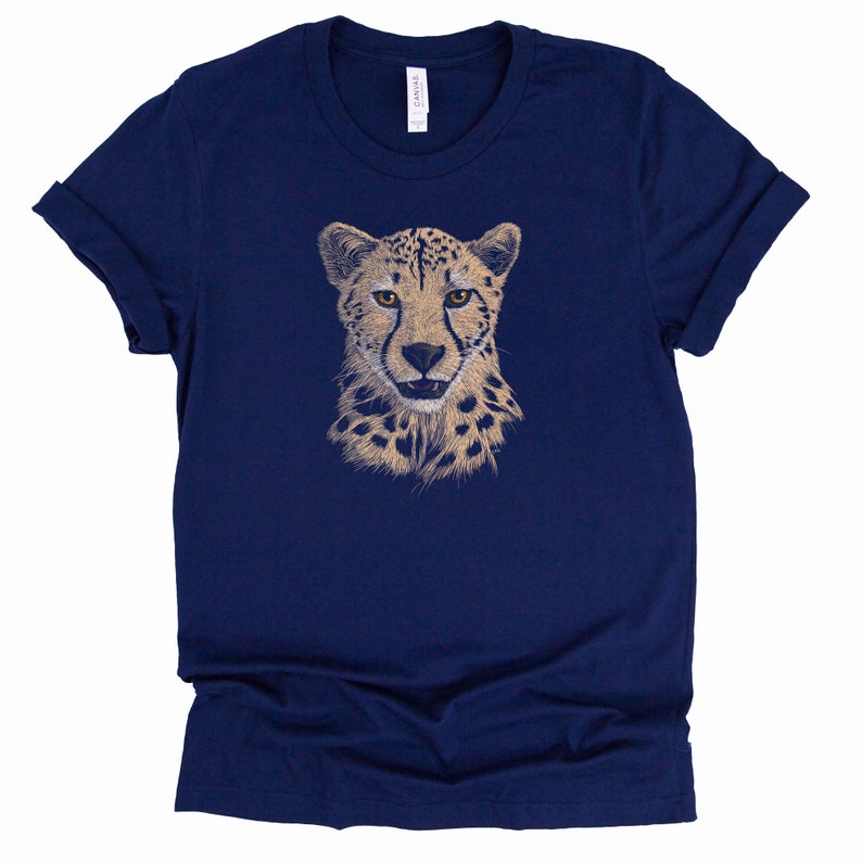 May include: A navy blue t-shirt with a graphic of a cheetah's face in beige and brown.
