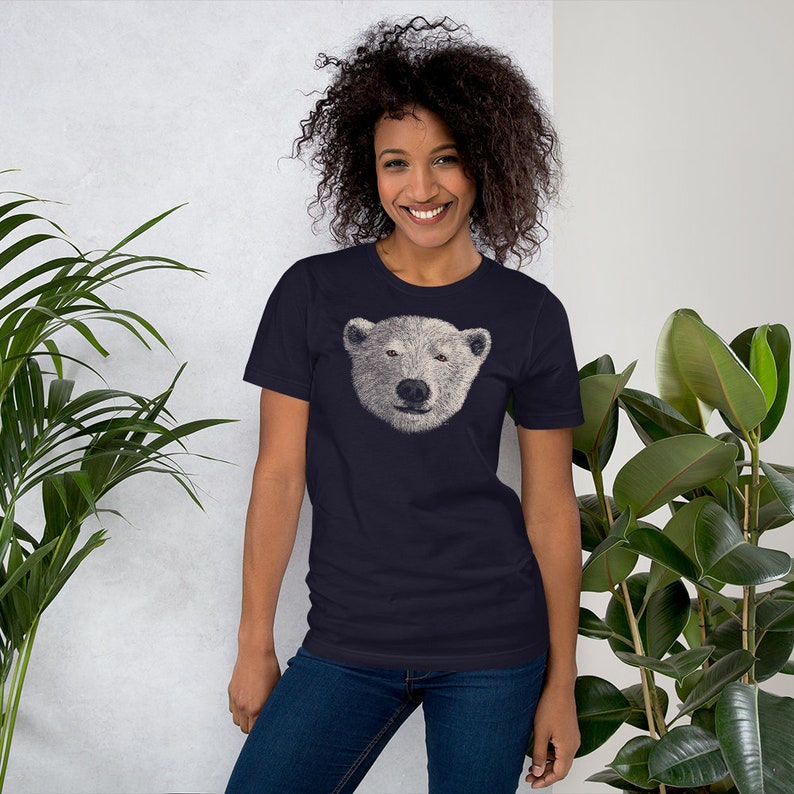May include: A navy blue t-shirt featuring a white polar bear face graphic.