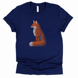 May include: A navy blue t-shirt featuring a graphic of a red fox sitting with its tail curled around its body.