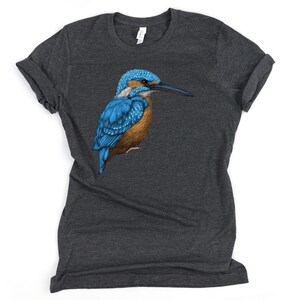 May include: A dark heather grey t-shirt with a blue and brown kingfisher bird illustration.
