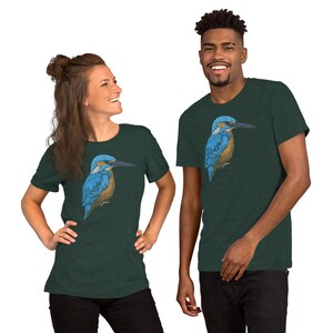 May include: Two people wearing dark green t-shirts with a blue and brown kingfisher bird graphic printed on the front.