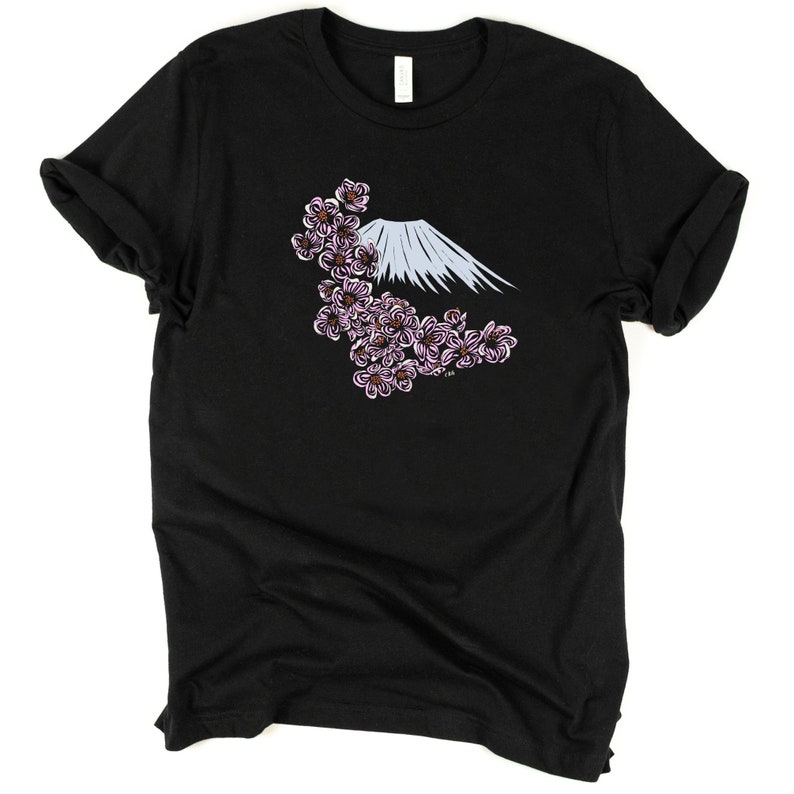 May include: Black t-shirt with a white and blue mountain and pink cherry blossoms graphic.