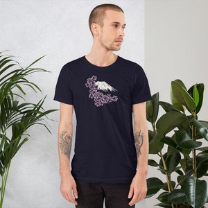 May include: A navy blue t-shirt with a white graphic of Mount Fuji with pink cherry blossoms.