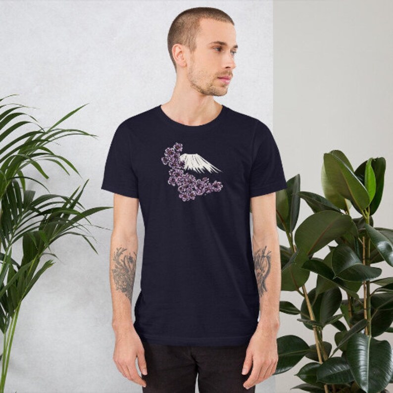 May include: A navy blue t-shirt with a white graphic of Mount Fuji with pink cherry blossoms.