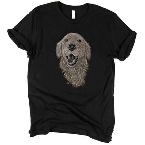 May include: Black t-shirt with a detailed illustration of a golden retriever dog's head. The dog is looking directly at the viewer with its mouth open in a happy expression.