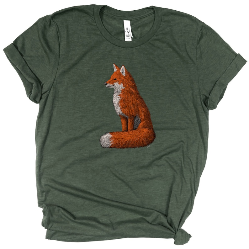 May include: A green t-shirt featuring a graphic of a red fox sitting with its tail curled around its body.