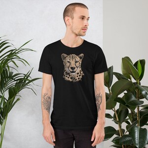 May include: A black t-shirt with a graphic of a cheetah's face. The cheetah is drawn in a realistic style with brown and tan fur.