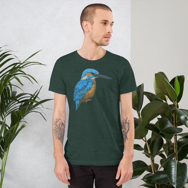 May include: A dark green t-shirt with a blue and brown kingfisher bird graphic.