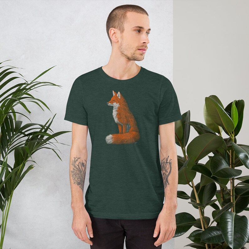 May include: A dark green t-shirt featuring a graphic of a red fox sitting with its tail curled around its body.
