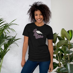 May include: A black t-shirt with a white graphic of Mount Fuji and pink cherry blossoms.
