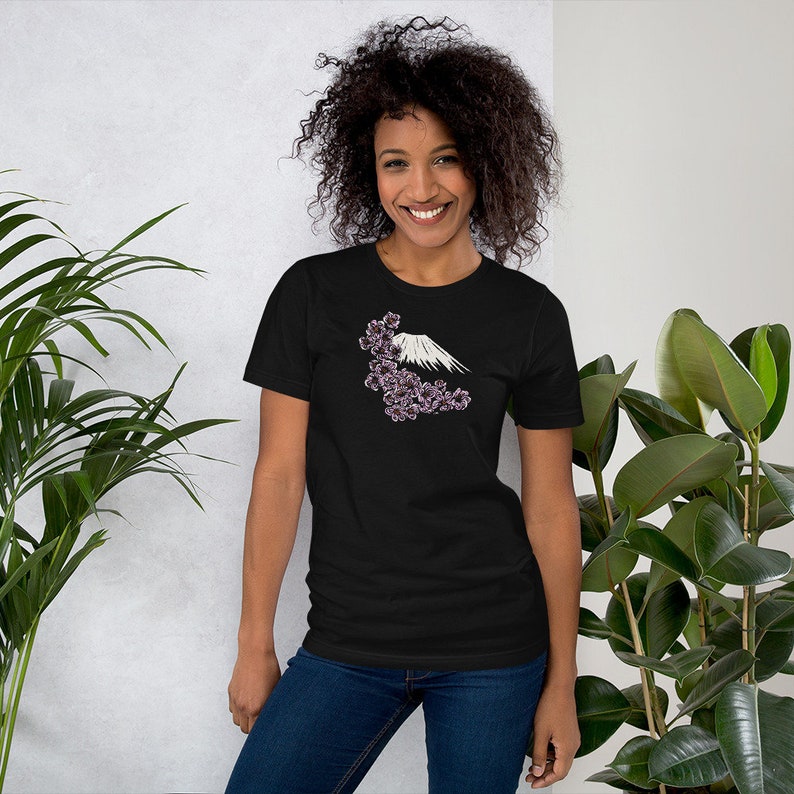 May include: A black t-shirt with a white graphic of Mount Fuji and pink cherry blossoms.