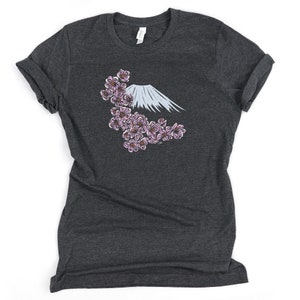 May include: A dark heather grey t-shirt with a graphic of Mount Fuji and pink cherry blossoms.