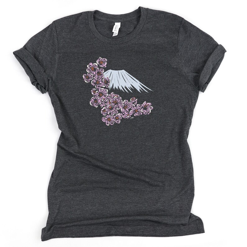 May include: A dark heather grey t-shirt with a graphic of Mount Fuji and pink cherry blossoms.