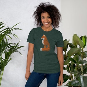 May include: A dark green t-shirt featuring a graphic of an orange fox sitting with its tail curled around its body.