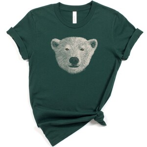 May include: A dark green t-shirt with a white polar bear face graphic printed on the front.