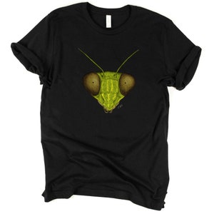 May include: Black t-shirt with a green praying mantis face graphic. The mantis has large, brown eyes and a detailed drawing style.