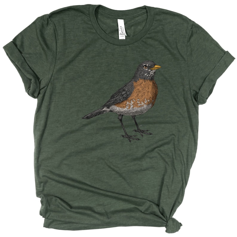 May include: A green t-shirt with a black and brown robin illustration on the front.
