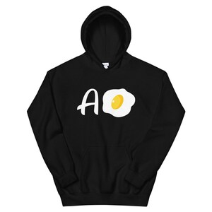 May include: Black hooded sweatshirt with a white graphic of a fried egg and the letters "AO".