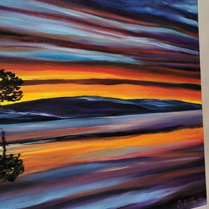 May include: An original oil painting on canvas depicting a vibrant sunset over a body of water. The artwork features bold brushstrokes in shades of orange, yellow, blue, and purple, with a silhouette of a tree in the foreground. The painting is displayed on a wooden easel.