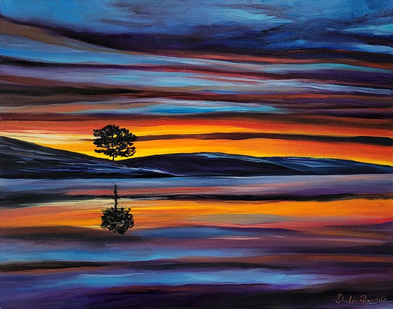 May include: An original landscape painting depicts a serene scene with a lone tree reflected in calm water. The sky is ablaze with vibrant hues of orange, yellow, and blue, creating a dramatic sunset effect. The artwork is signed in the lower right corner.