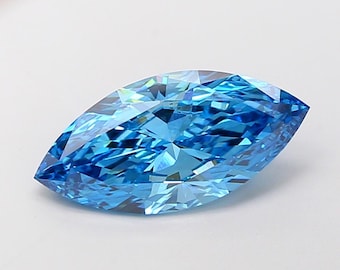 May include: A marquise-cut gemstone with a brilliant, faceted design. The gem is a vibrant, light blue colour, with a polished, reflective surface. The gemstone is set against a plain white background.